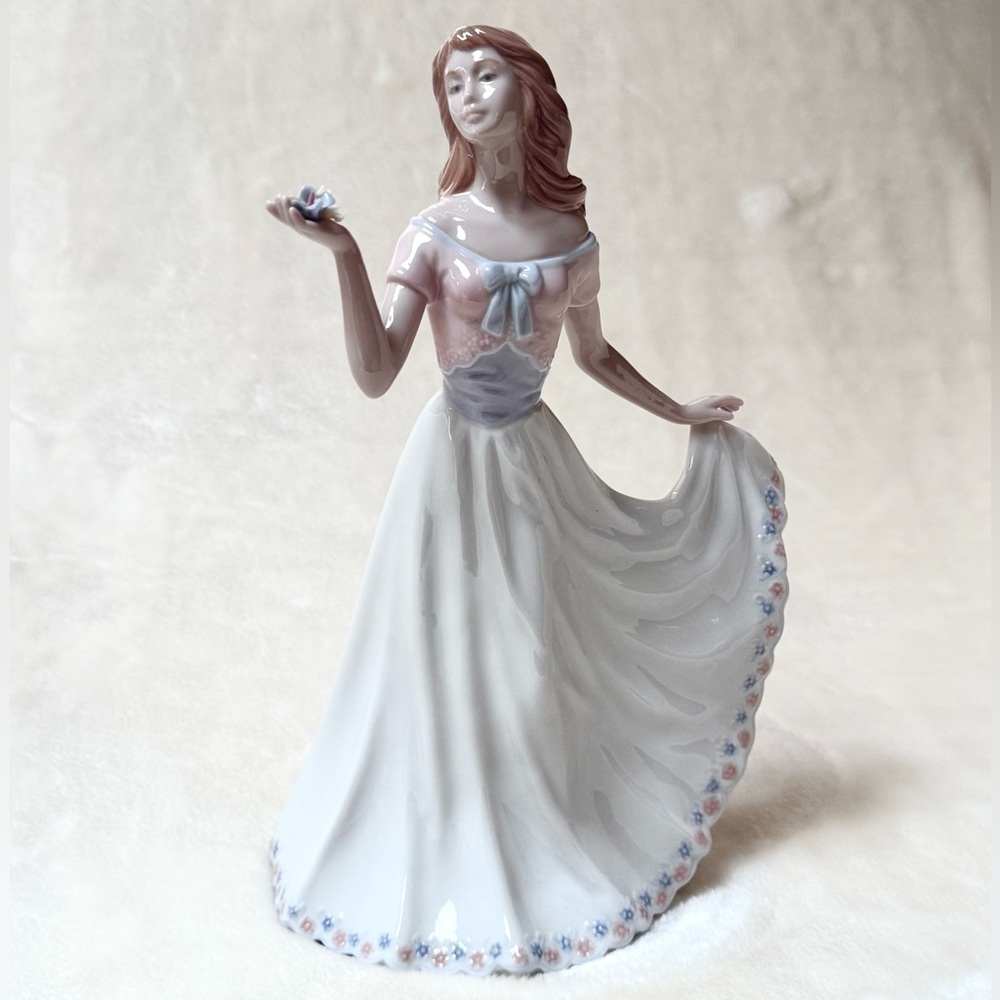 Nadal Porcelain Figurine “ Lady with flowers in Blue and Pink Accents.